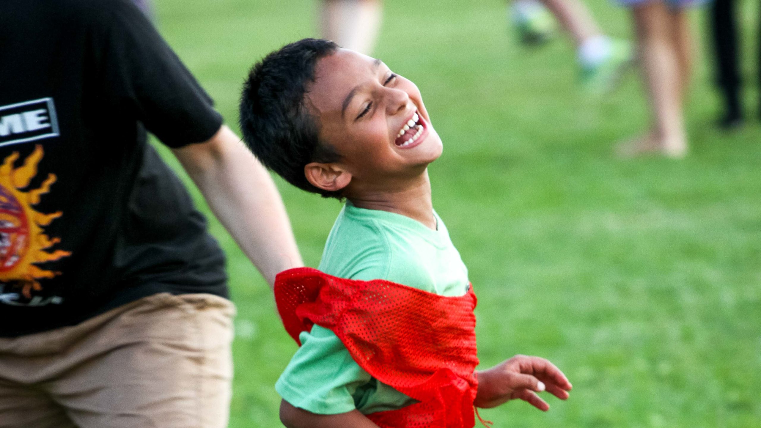 A camper running and smiling.