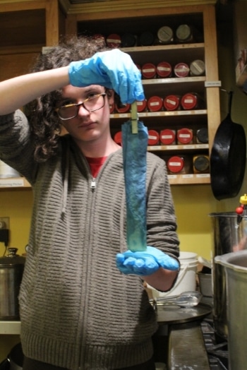 Jeremy with handmade indigo-dyed fabric during a dyeing workshop.