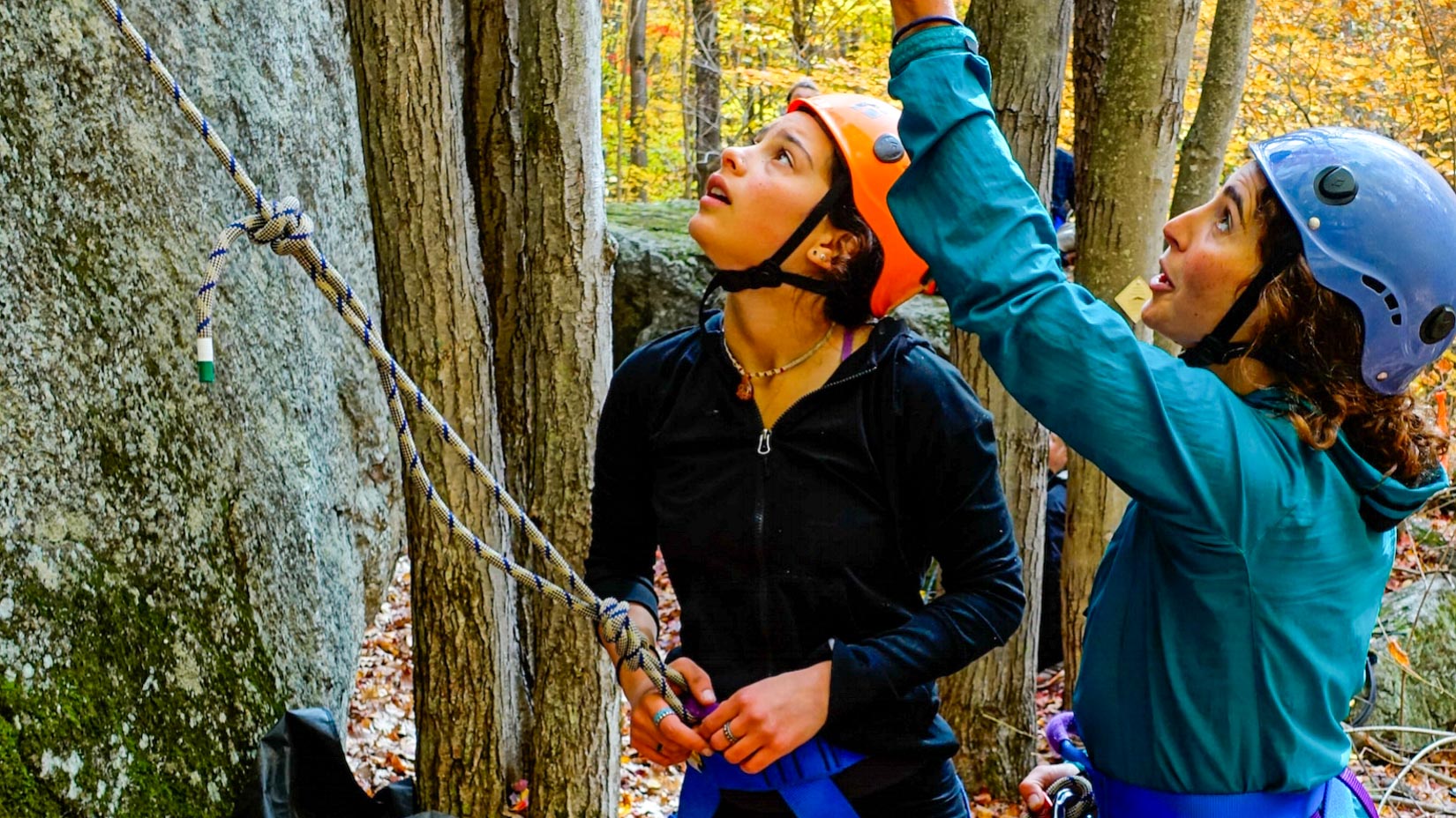 Counselors learning how to climb up rocks