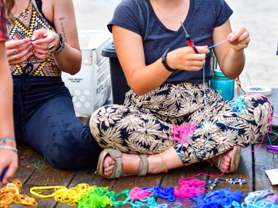Campers working on friendship bracelets