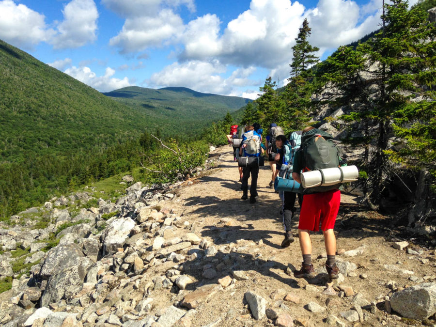 Campers hiking on a trail.