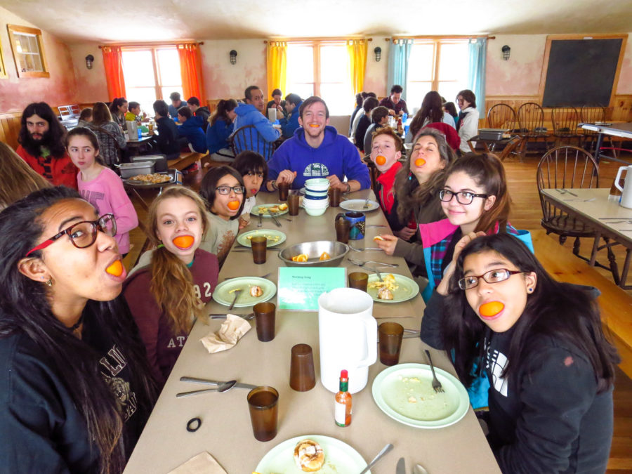 Campers sitting around a table in the winter.