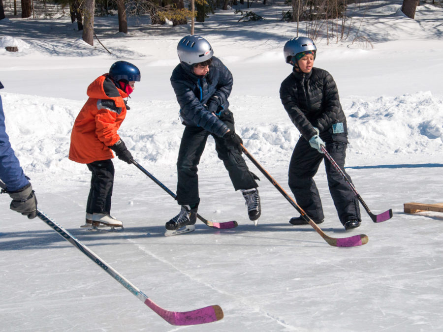 Campers playing ice hockey.