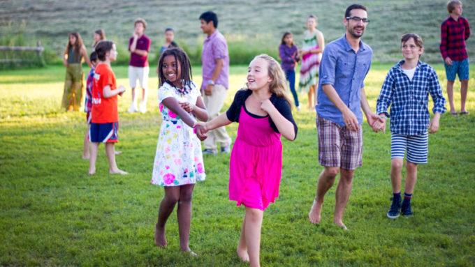 Campers running in a field.