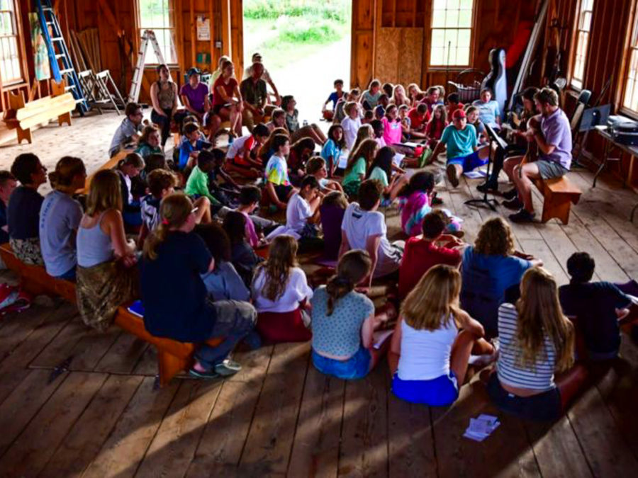 Campers gathering to listen to a performance