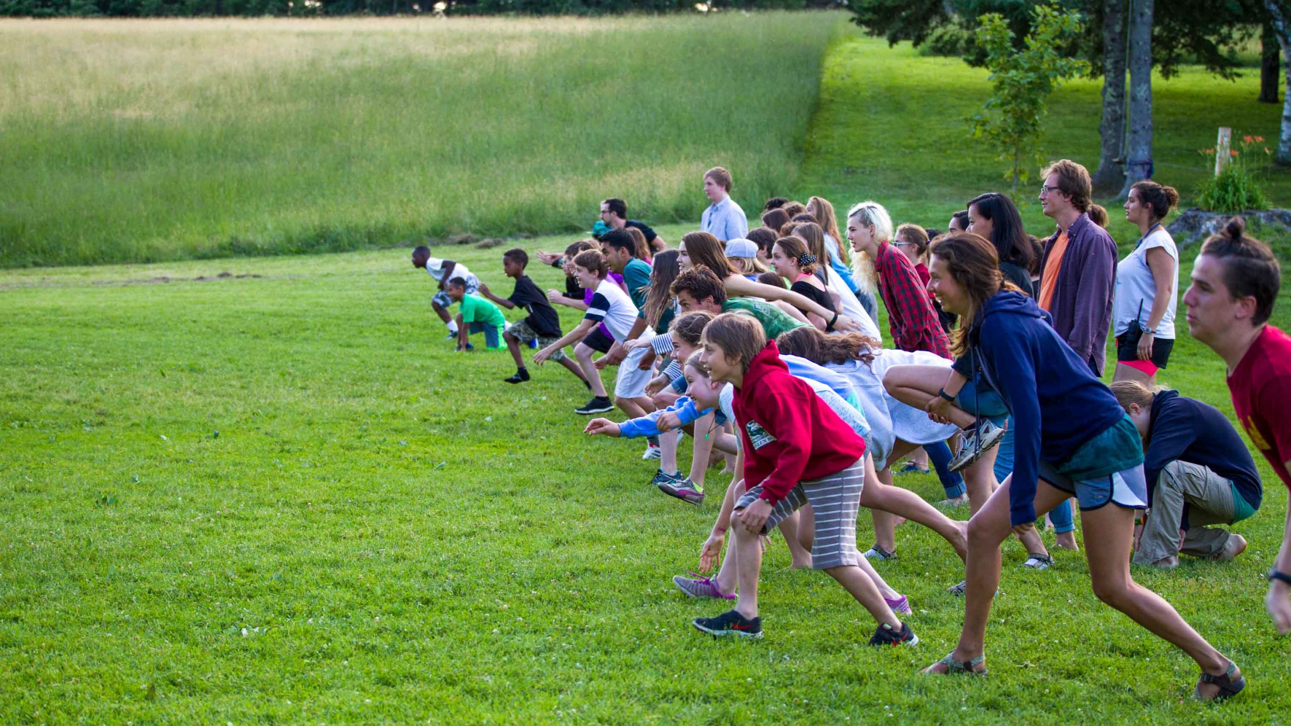 Campers getting ready to run across a field