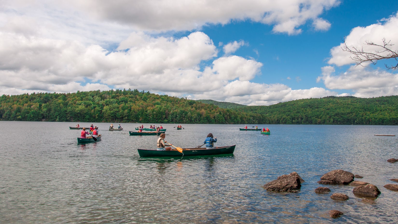 Campers exploring the lake in canoes.