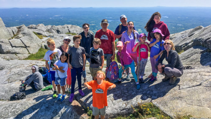 Family campers hiking on a mountain