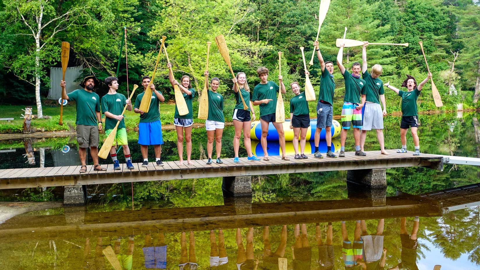 Campers on a bridge with paddles