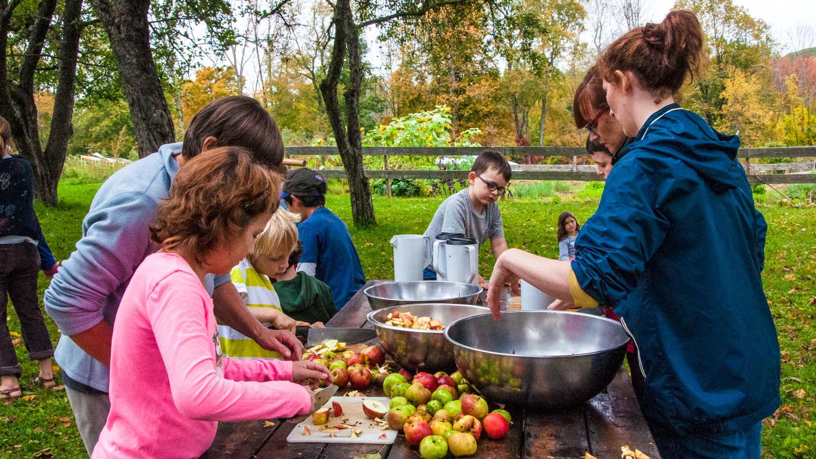 A group of campers peeling apples
