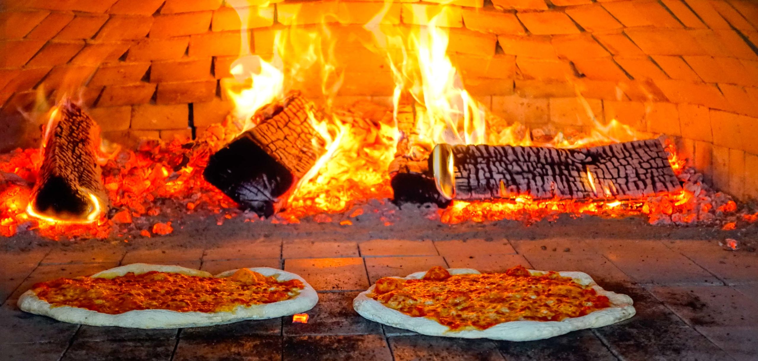 Pizzas being fired in a wood burning stove.