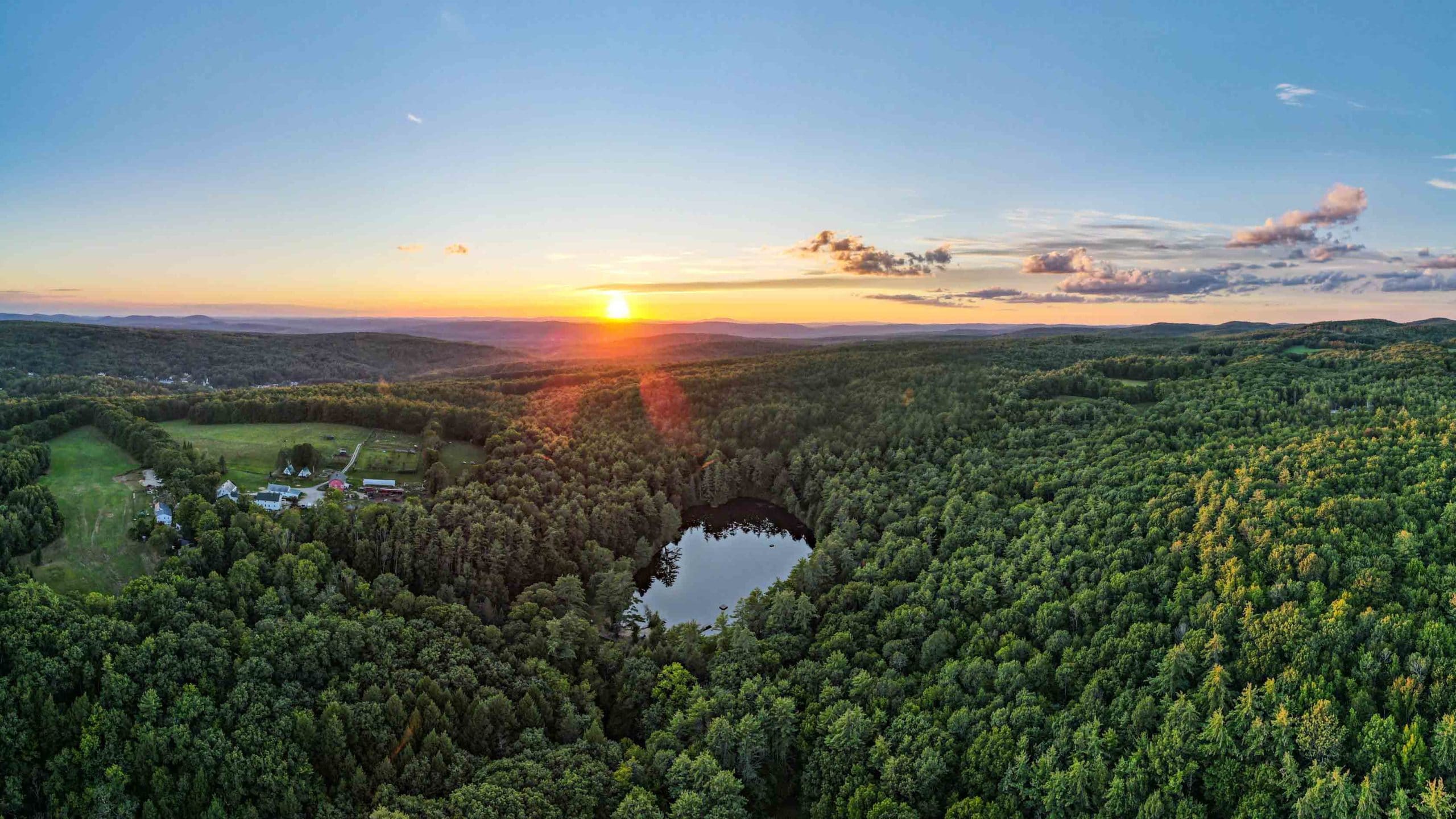 A sunset over the camp grounds and forest.