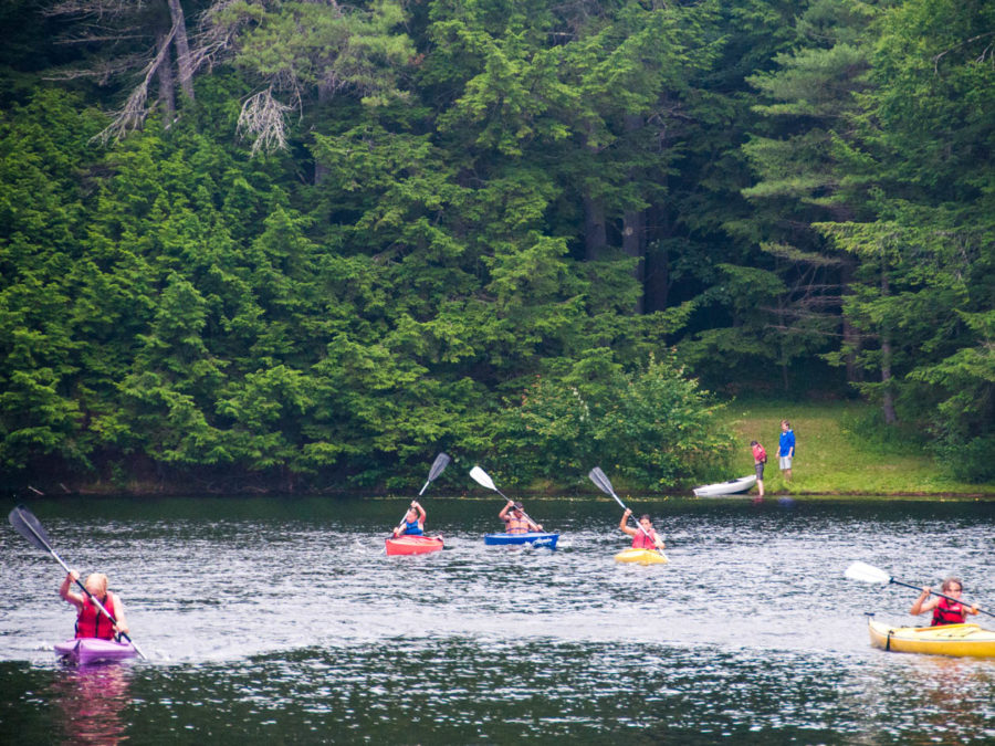 Campers kayaking in the lake.