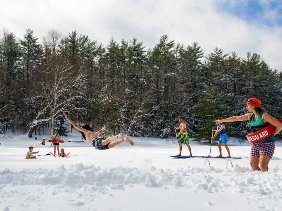 Campers staging a photo in the snow to look like a pool.